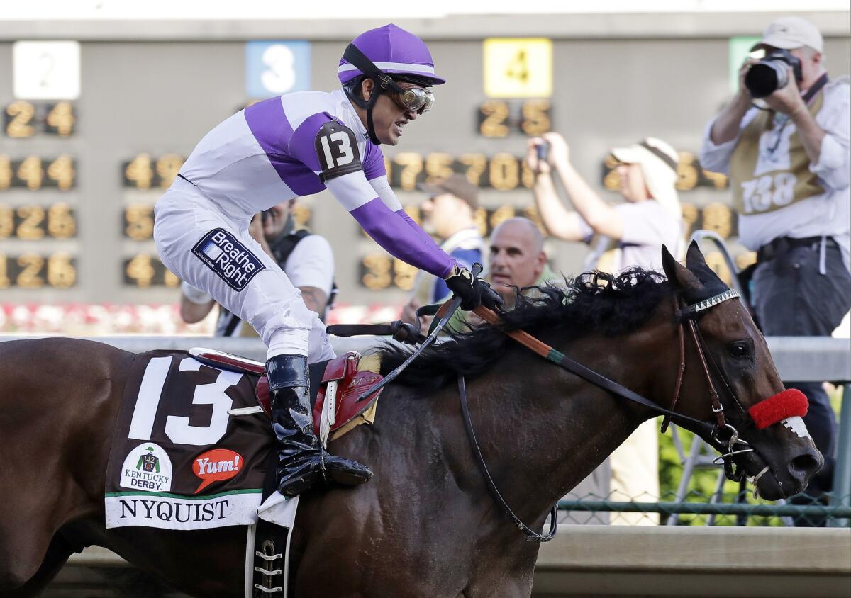 Mario Guitierrez celebrates after riding Nyquist to victory during the 142nd running of the Kentucky Derby.