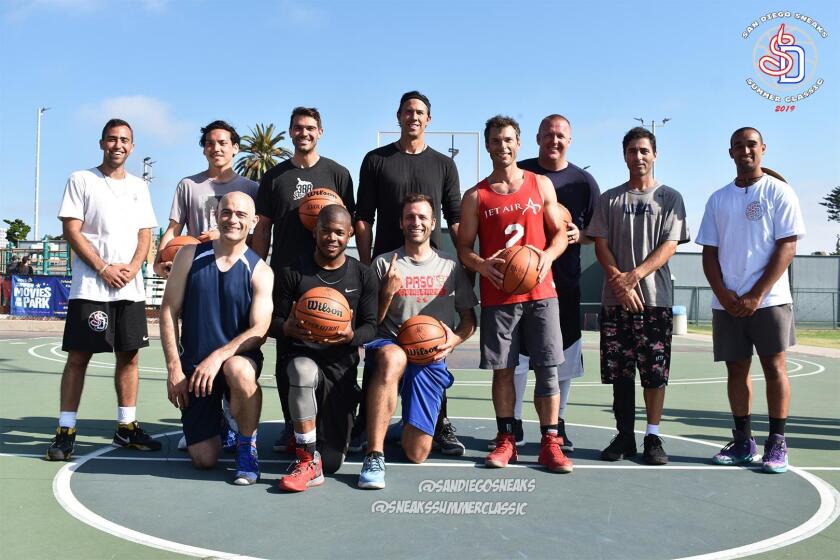 Sneaks Summer Classic co-founders Sawsun Khodapanah (far left) and Tyson Youngs (far right) pose with 2019 tournament winners, The 5 O’Clock Bandits team, and their customized prize basketballs, during the second annual Sneaks Summer Classic basketball tournament held July 6, 2019 at La Jolla Recreation Center