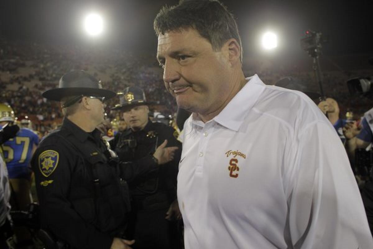 USC interim coach Ed Orgeron leaves the field after a 35-14 loss to UCLA on Saturday at the Coliseum. The Trojans were 6-2 under Orgeron.