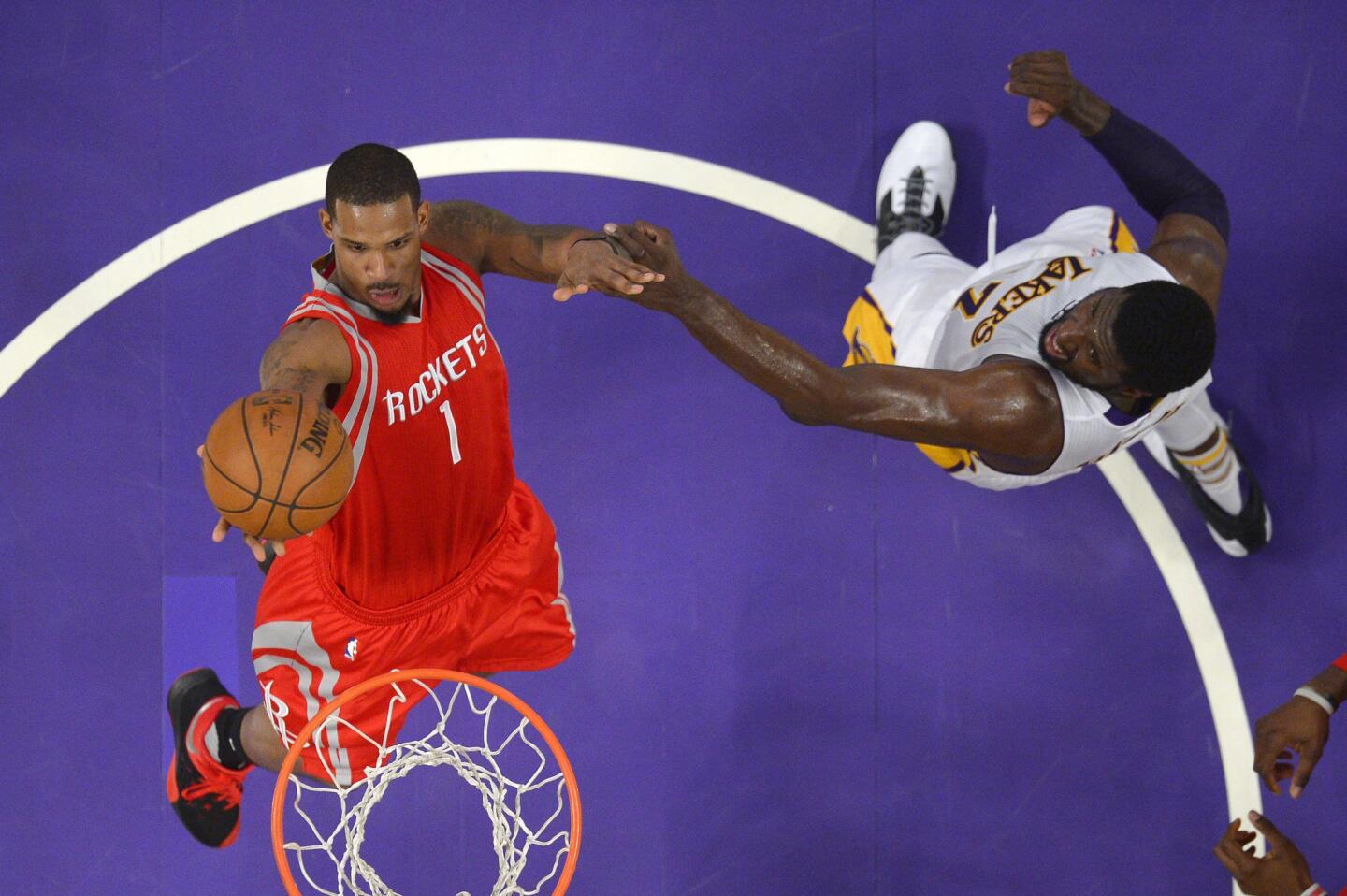 Houston Rockets forward Trevor Ariza, left, shoots as Los Angeles Lakers center Roy Hibbert defends during the second half on Sunday.