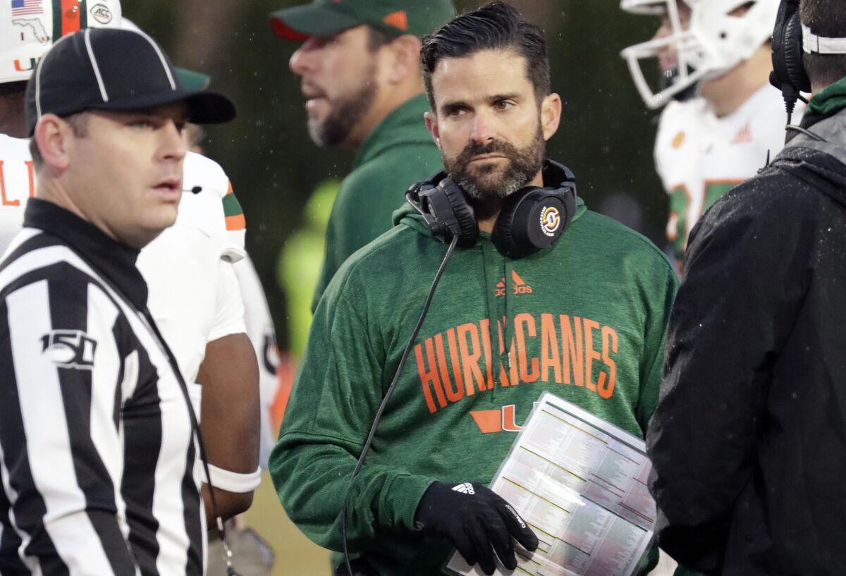 Miami coach Manny Diaz listens to an official.