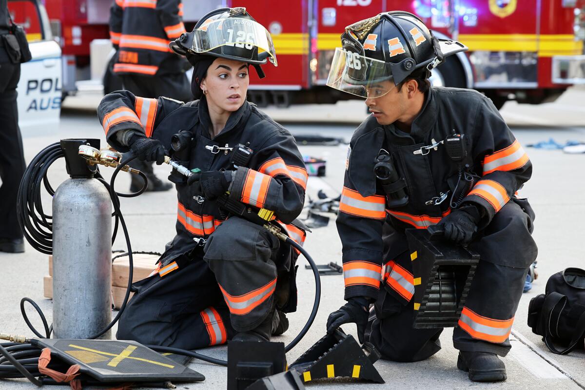 Natacha Karam and Julian Works in emergency response gear