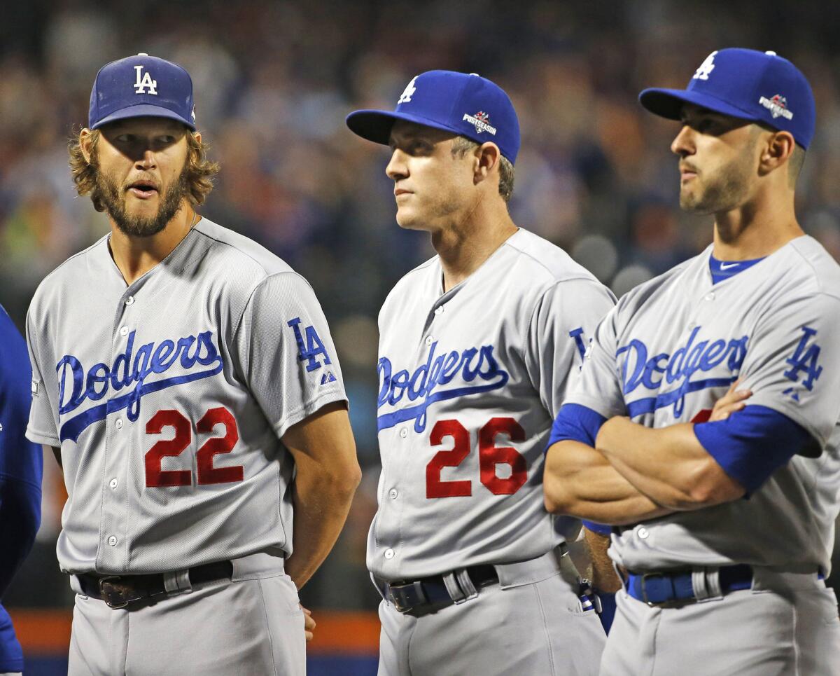 Clayton Kershaw (22) glances at Chase Utley (26) as the crowd boos Utley during introductions before Game 3 of the National League division series against the New York Mets.