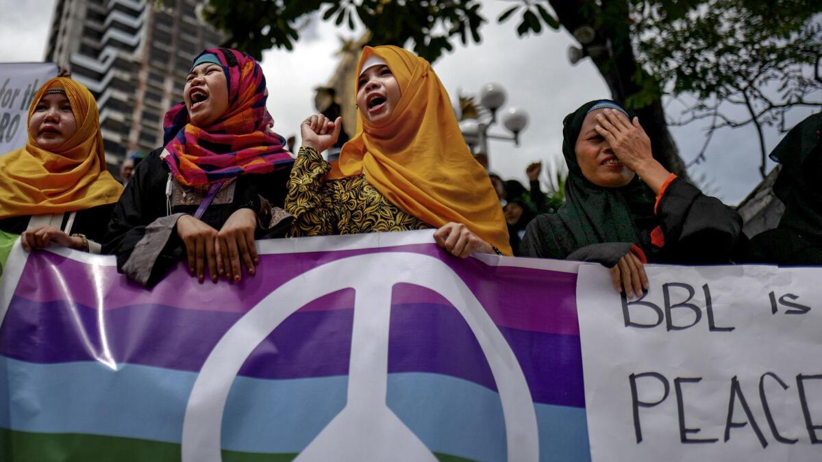 Muslim and Christian activists hold a protest July 11 in Manila during talks among Philippine lawmakers that would determine the fate of the Muslim community's bid for self-governance and self-determination.