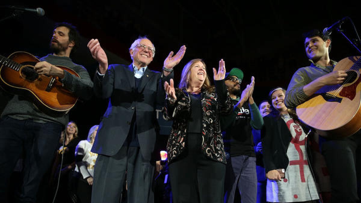 Bernie Sanders and his wife, Jane O'Meara Sanders, join Vampire Weekend on stage at a campaign event in Iowa City.