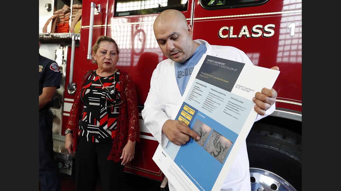 Glendale Adventist Medical Center Doctor Yaser Badr, MD points to images taken at the cite of a stroke inside the head of Silvana Shiravnian, left, at the Glendale Fire Department Station 25 on Wednesday, November 8, 2017. On August 8, 2917, Shiravnian had a massive stroke and was initially treated by Glendale Fire Station 25 paramedics before being transferred to Glendale Adventist Medical Center. Shiravnian came to the firehouse to thank the first responders who saved her life.