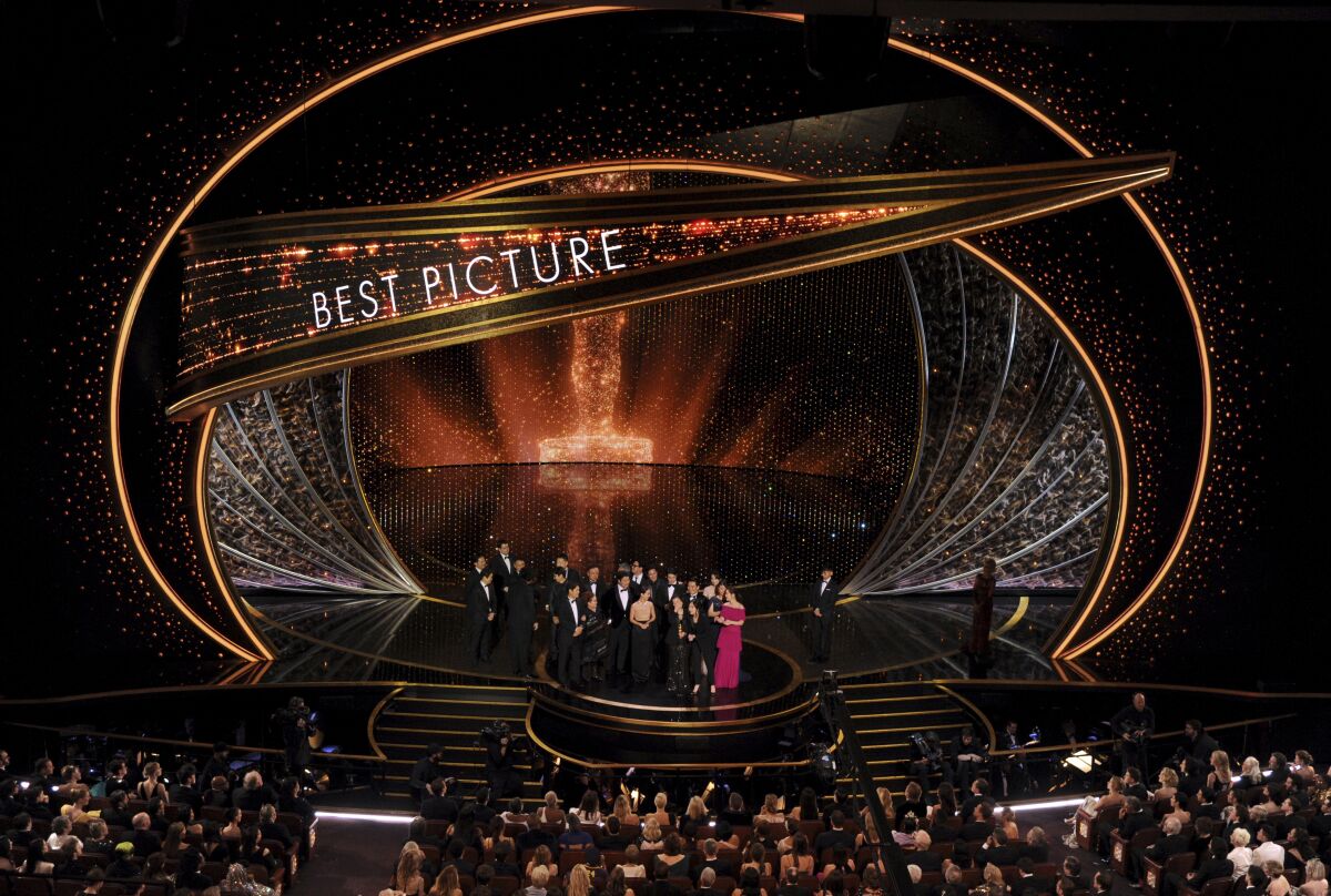 The cast and crew of "Parasite" accept the award for best picture at the Oscars on Sunday.