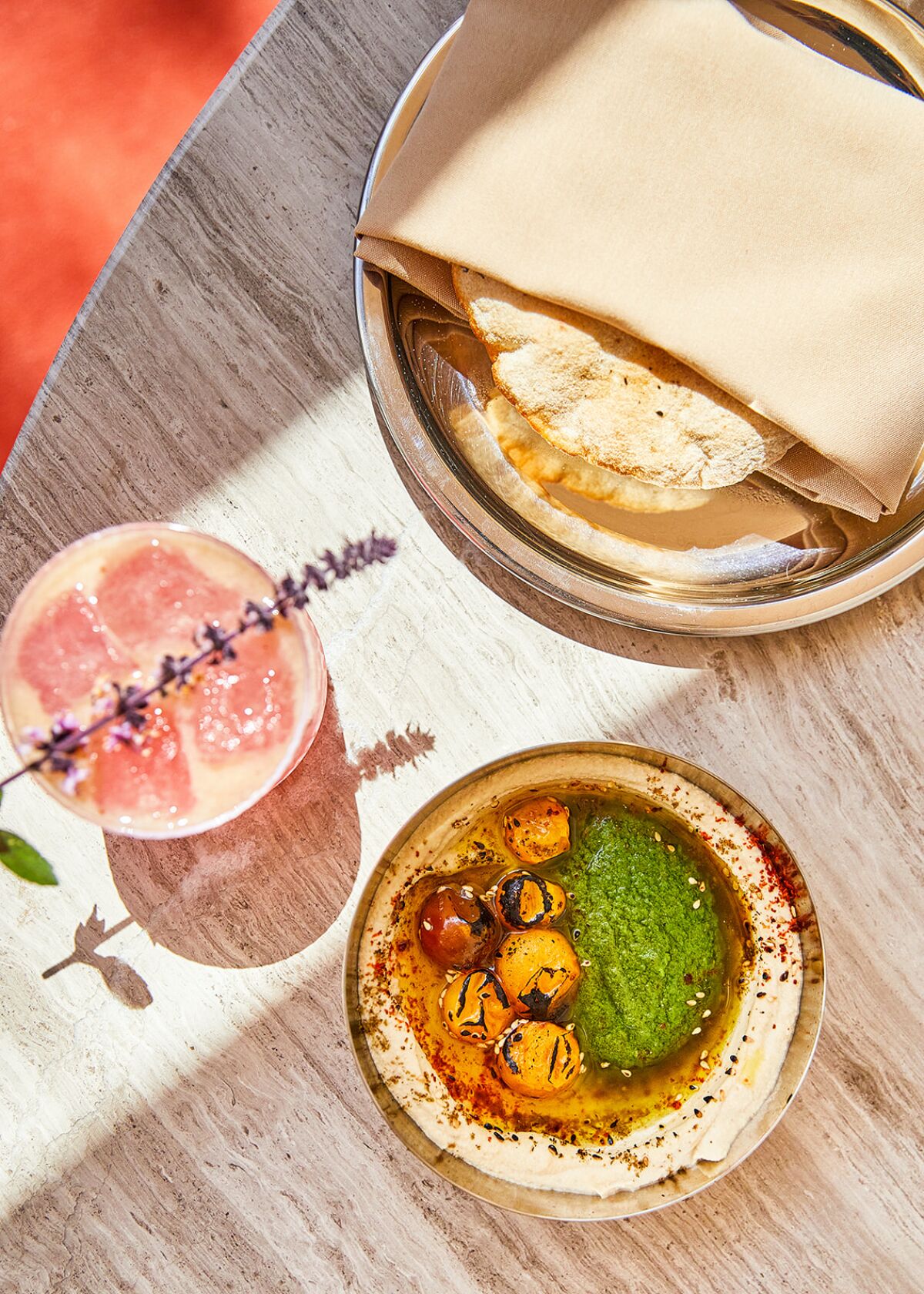 Pita bread, hummus and a cocktail are menu starters at Callie restaurant, opening June 4 in East Village.