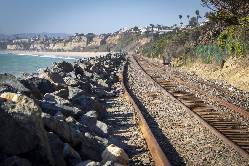 San Clemente, CA - September 21: Rocks and tracks next to La Casa Pacifica (previously owned by President Richard Nixon) located in the gated community of Cottons Point Estates/Cypress Shores at Cotton's Point in San Clemente. Metrolink and Amtrak have been forced to suspend service between Orange and San Diego counties for several weeks as crews conduct emergency repairs caused by beach erosion in San Clemente Tuesday, Sept. 21, 2021. The Cyprus Shores gated community has been impacted by erosion. (Allen J. Schaben / Los Angeles Times)