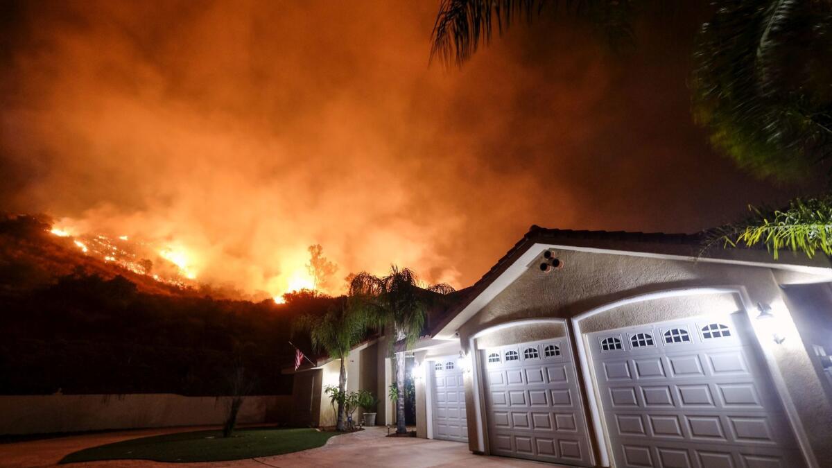 The Holy fire burns near homes in the Cleveland National Forest near Lake Elsinore on Aug. 9.