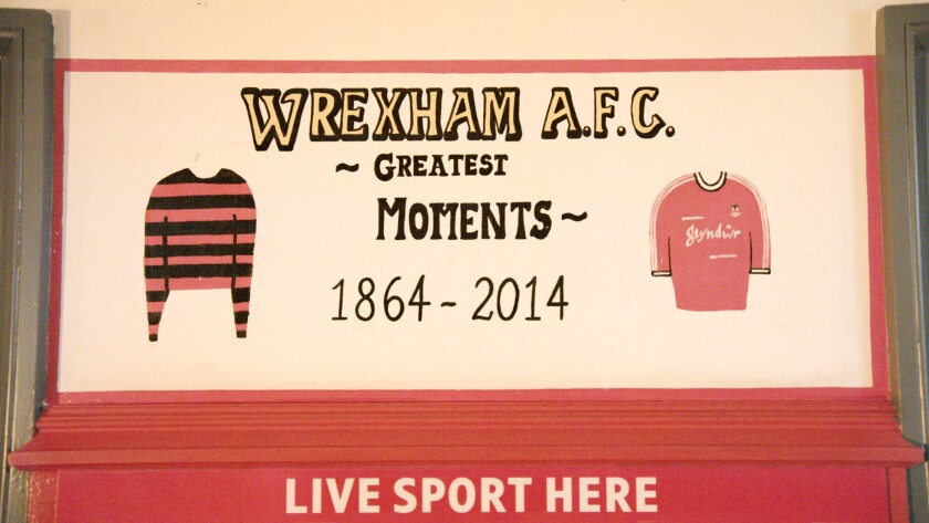 A red and white wall in a pub celebrating the Wrexham football club.