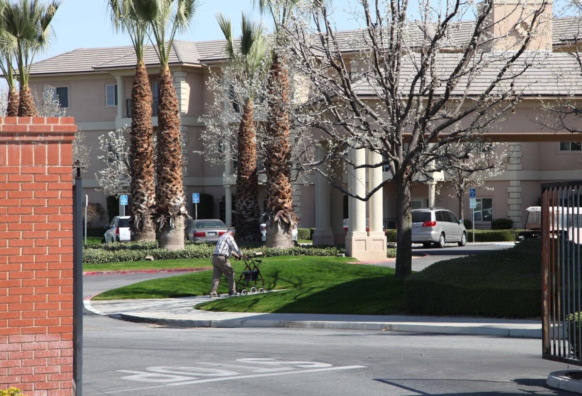 A man walks near the main gate of Glenwood Gardens in Bakersfield.
