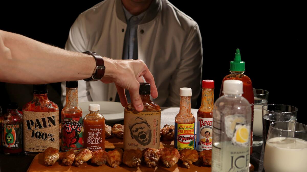 A collection of sauces used to coat the hot wings on the show "Hot Ones"