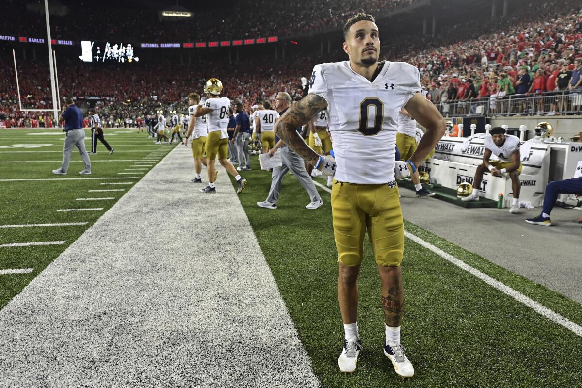 Notre Dame wide receiver Braden Lenzy looks at the scoreboard during the fourth quarter of the team's NCAA college football game against Ohio State, Saturday, Sept. 3, 2022, in Columbus, Ohio. Ohio State won 21-10. (AP Photo/David Dermer)