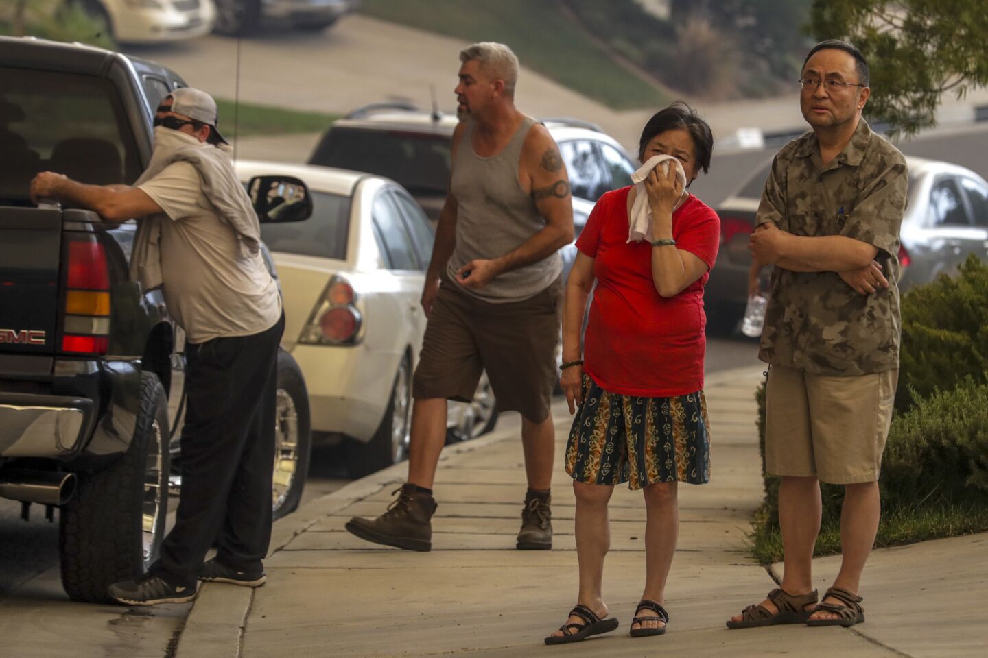 Worried residents watch as flames advance toward their homes on Sandpiper Drive in Lake Elsinore.