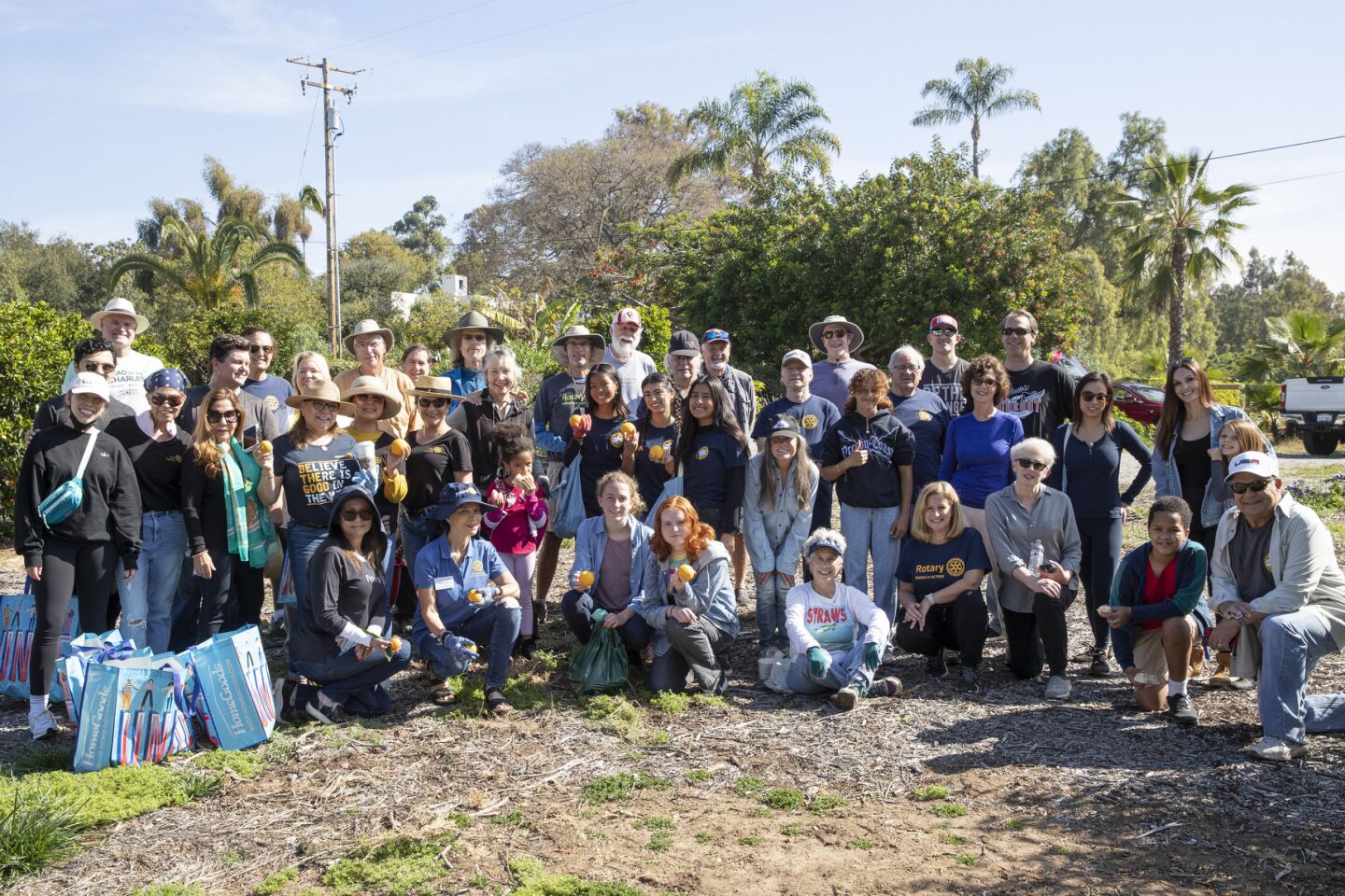 Rotary Club members from Encinitas, Del Mar, and Solana Beach recently gathered to pick oranges at a Rancho Santa Fe estate and donated them to the Community Resource Center in Encinitas.