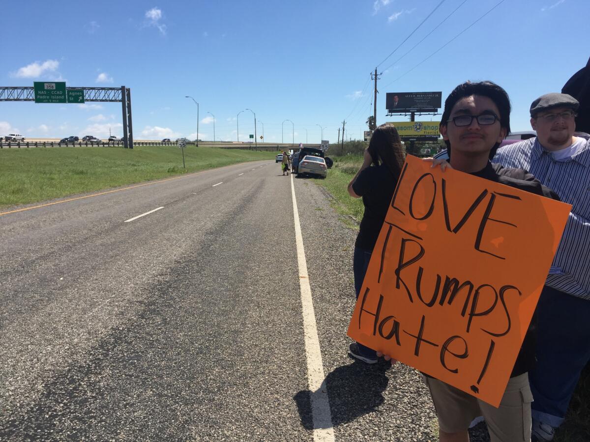 Ben Falcon, 17, born and raised in Corpus Christi, Texas, protests President Trump's arrival at his hometown Tuesday.