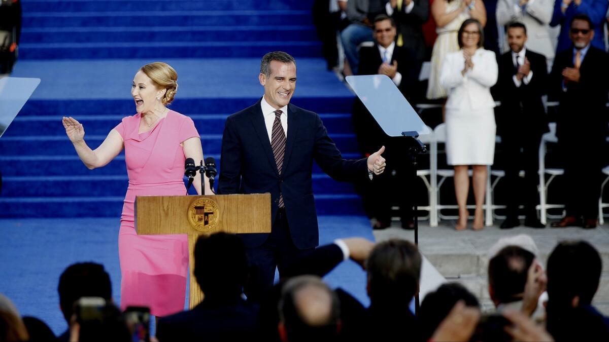 Mayor Eric Garcetti and his wife, Amy Wakeland, greet the crowd outside L.A. City Hall before his swearing-in for his second term.