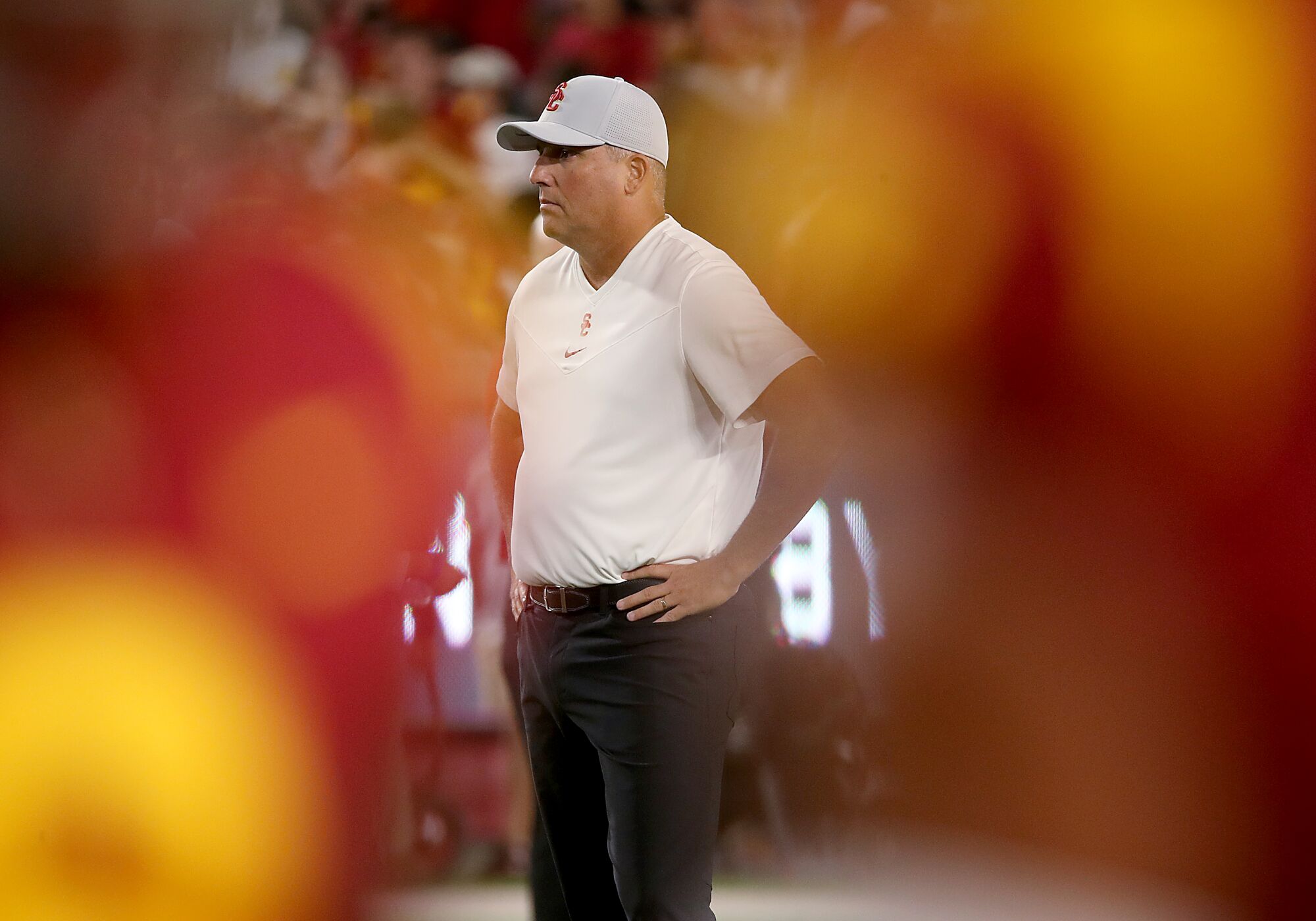 USC head coach Clay Helton watches the Trojans warm up before a game against Stanford