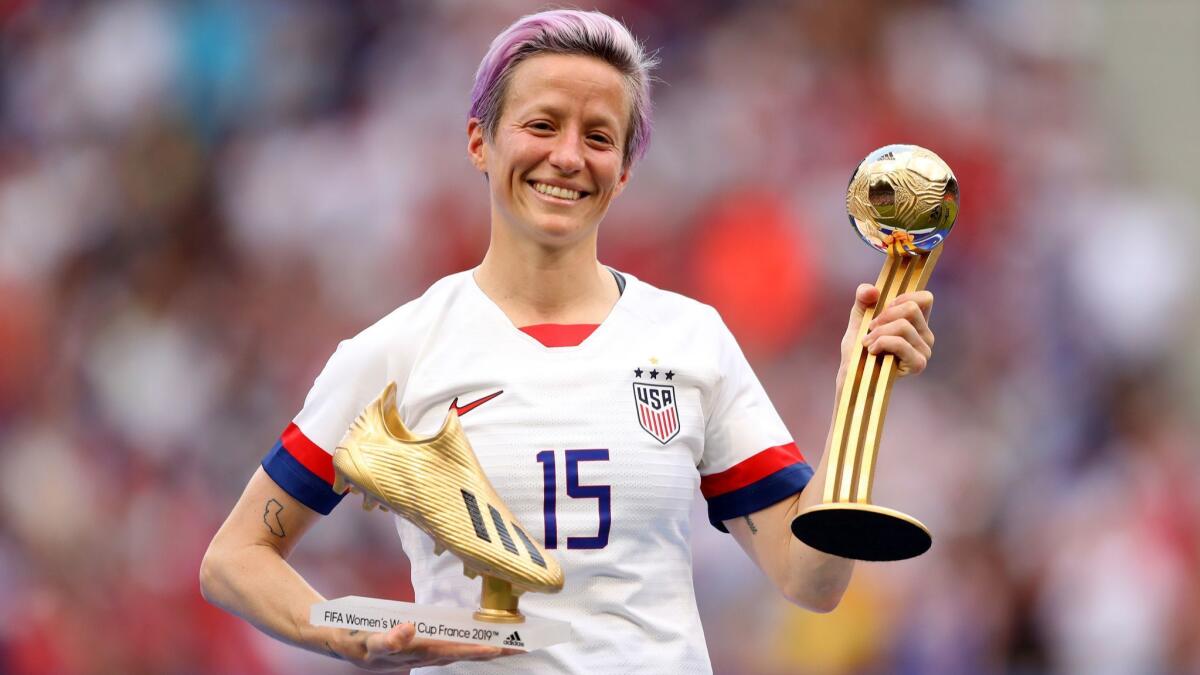 Megan Rapinoe of the USA poses for a photograph with the Golden Boot award and the Golden Ball award after the 2019 FIFA Women's World Cup France Final match between the United States and the Netherlands at Stade de Lyon on July 07, 2019, in Lyon, France.