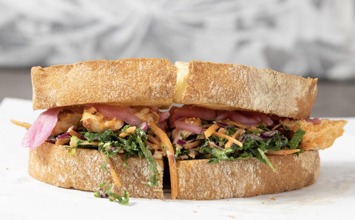 The Slawpy sandwich features hot chicken topped with kale, cabbage, carrots and pickled onion.