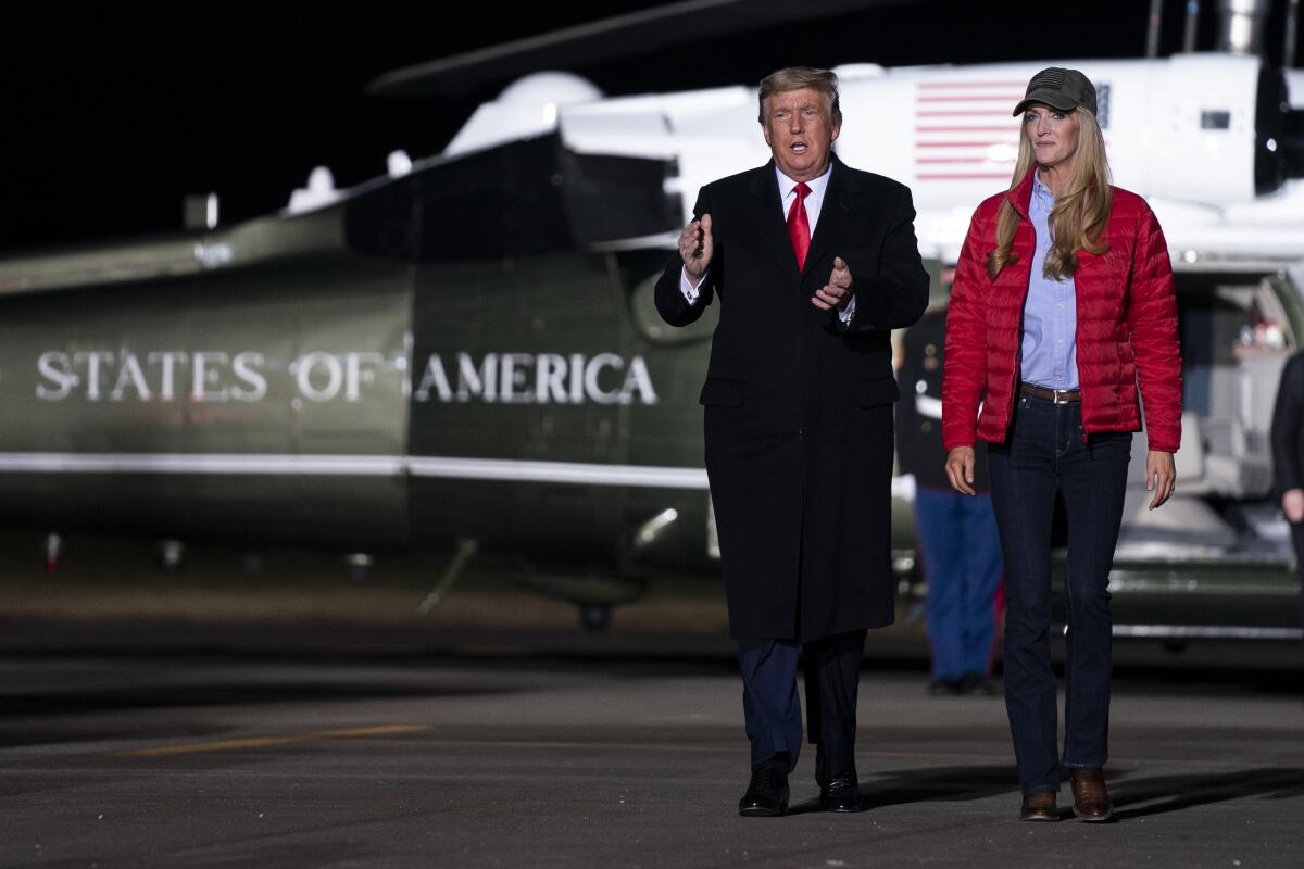 President Trump walks away from Marine One with Sen. Kelly Loeffler (R-Ga.) on Jan. 4.