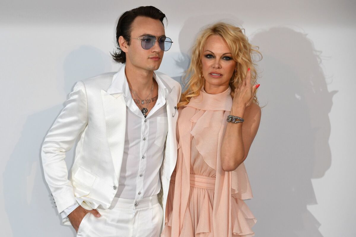Brandon Thomas Lee and his mother, Pamela Anderson, stop for photos as they arrive last month for amfAR's 26th Cinema Against AIDS gala at the Hotel du Cap-Eden-Roc in Cap d'Antibes in France.