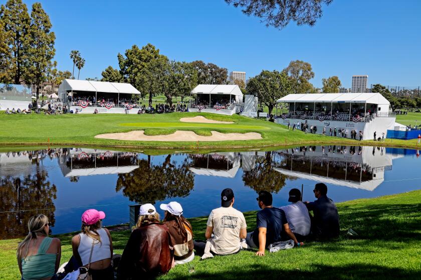 Onlookers take in the view from a grassy knoll overlooking Newport Beach Country Club at the Hoag Classic.