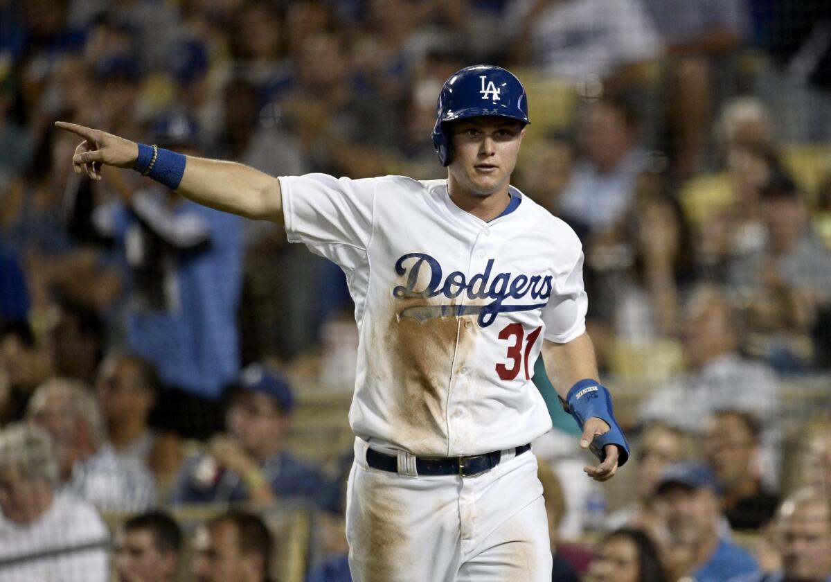 Joc Pederson acknowledges Carl Crawford after scoring on Crawford's double against the Washington Nationals on Aug. 12.