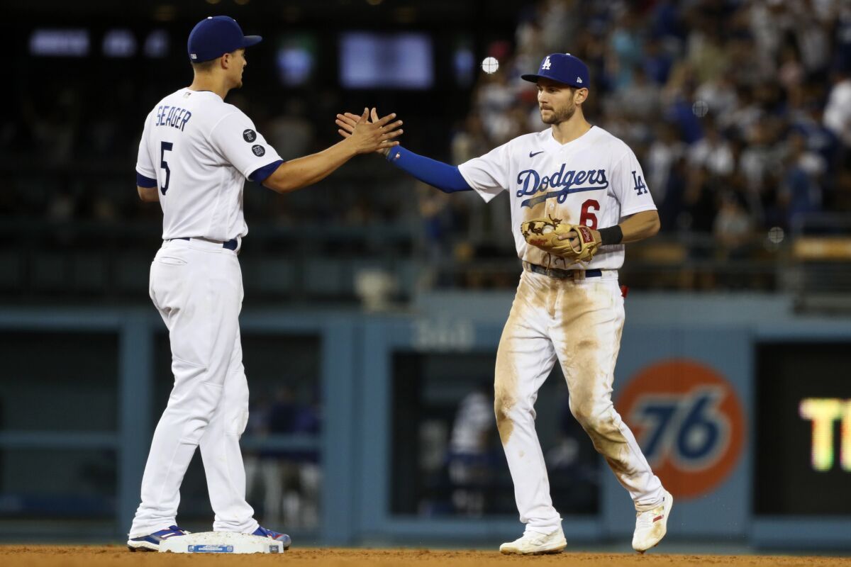 Shortstop Corey Seager, left, and new second baseman Trea Turner celebrate the Dodgers' win Aug. 7, 2021.