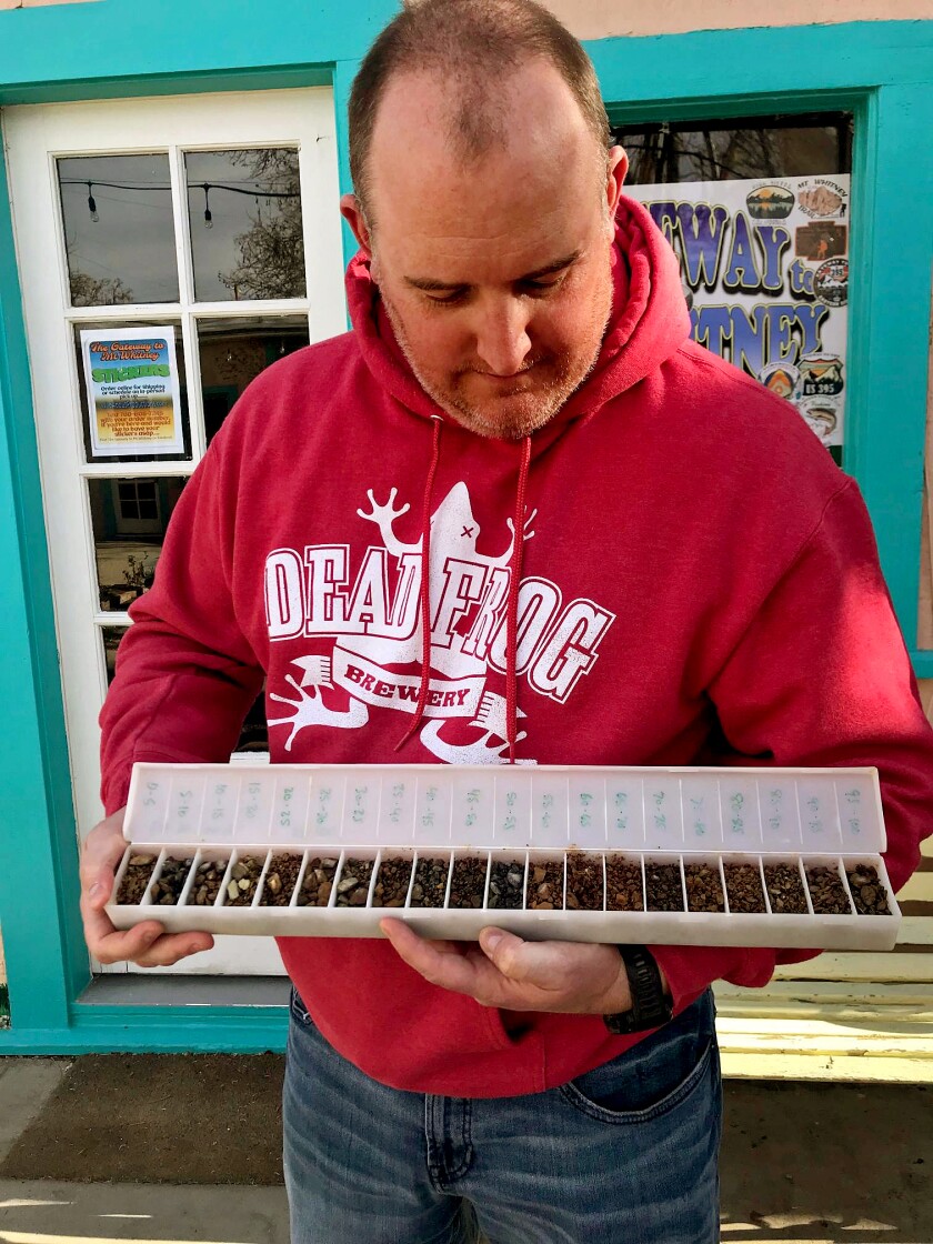 Jodie Gibson holds a tray of high-grade gold ore.