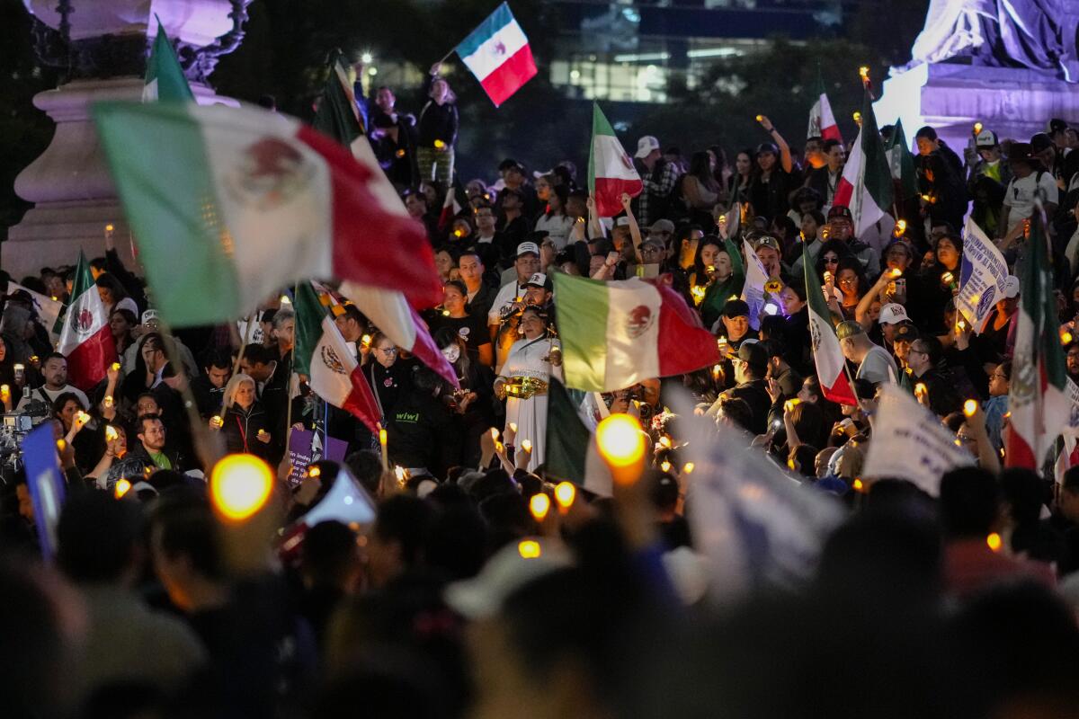 Protesters wave Mexican flags.