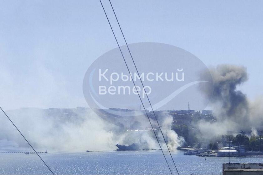 This image taken from UGC video shows smoke rising from the headquarters of Russia’s Black Sea Fleet in Sevastopol, Crimea, Friday Sept. 22, 2023. Ukraine carried out a fiery missile strike Friday on the main headquarters of Russia’s Black Sea Fleet and one serviceman was missing, the Russian Defense Ministry said (Crimean Telegram channel via AP)