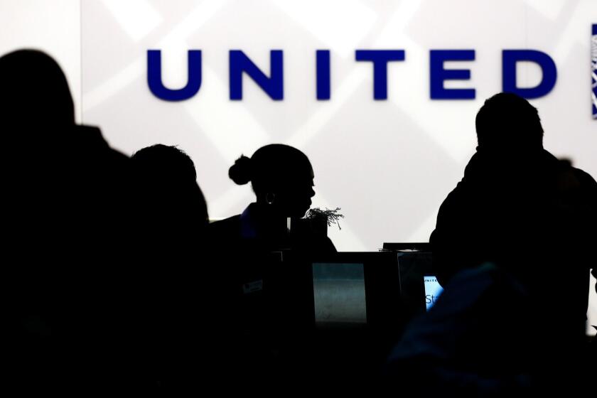 FILE - In this Saturday, Dec. 21, 2013, file photo, travelers check in at the United Airlines ticket counter at Terminal 1 in O'Hare International Airport in Chicago. After a man is dragged off a United Express flight on Sunday, April 9, 2017, United Airlines becomes the butt of jokes online and on late-night TV. Travel and public-relations experts say United has fumbled the situation from the start, but itâs impossible to know if the damage is temporary or lasting. Air travelers are drawn to the cheapest price no matter the name on the plane. (AP Photo/Nam Y. Huh, File)
