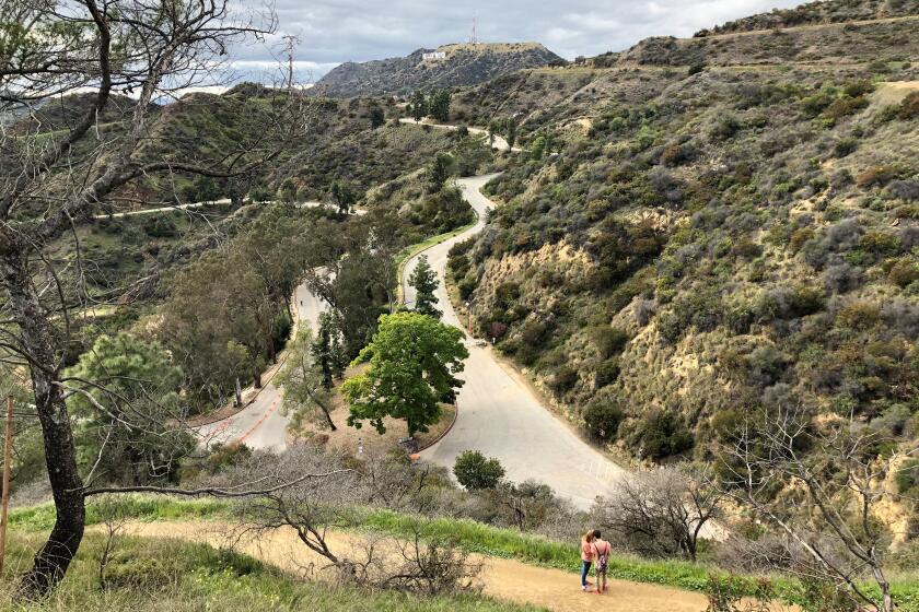 Griffith Park remained open Monday afternoon, but city officials warned that hikers need to keep their distance.