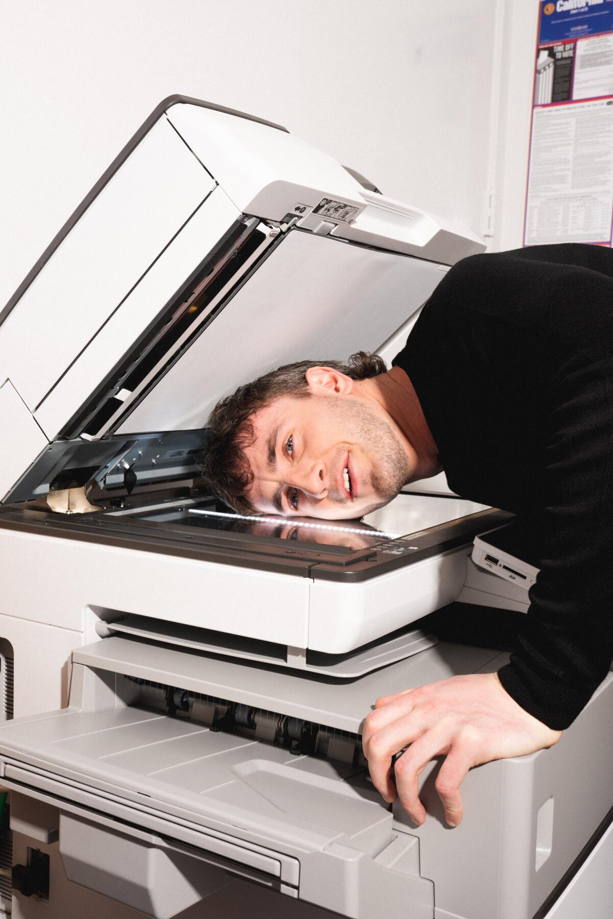 A man with the side of his face on a copy machine 