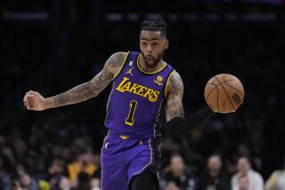 Los Angeles Lakers guard D'Angelo Russell (1) passes during the first half of an NBA basketball game.