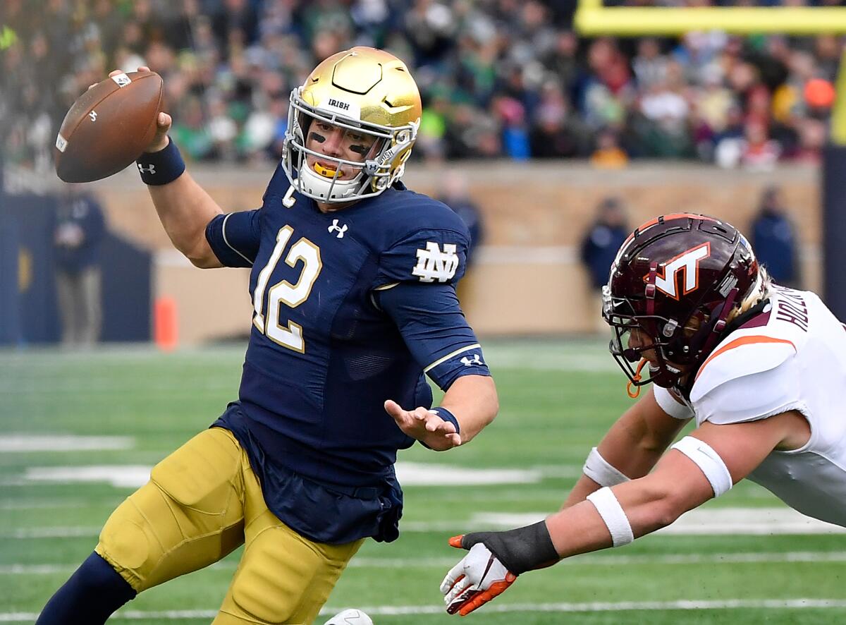 Notre Dame quarterback Ian Book scrambles against Virginia Tech on Saturday in South Bend, Ind.