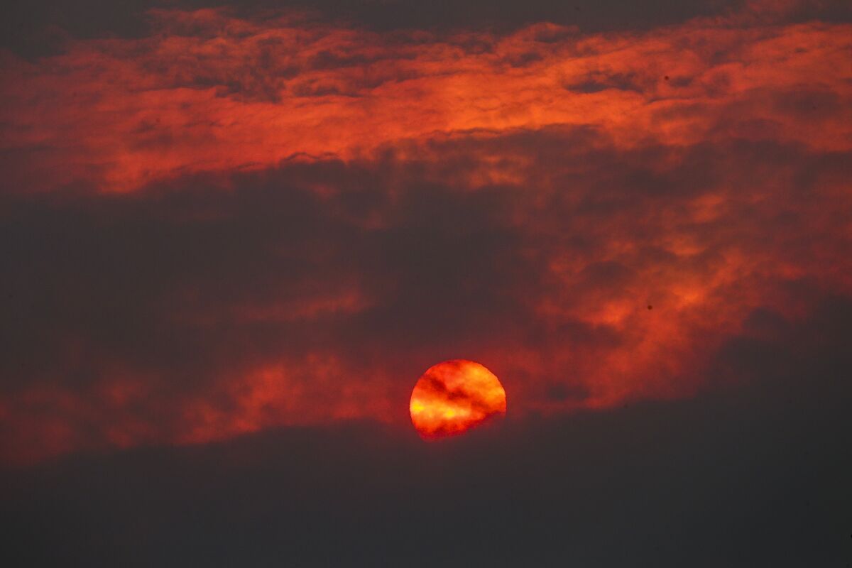 A view of the sunset obscured by heavy smoke from the Bobcat fire as seen from Littlerock, Calif., on Friday.