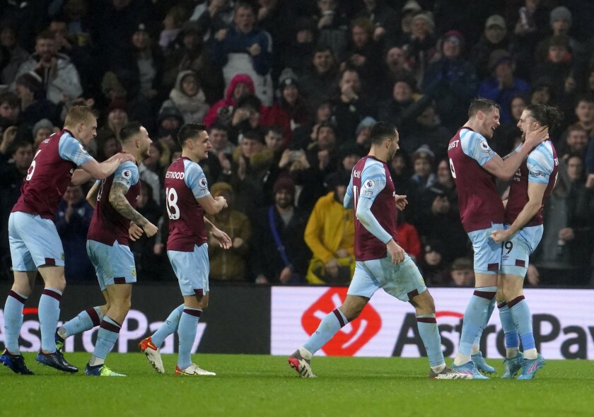 Burnley's Jay Rodriguez, right, celebrates with teammates after scoring his side's opening goal during the English Premier League soccer match between Burnley and Manchester United at Turf Moor, in Burnley, England, Tuesday, Feb. 8, 2022. (AP Photo/Jon Super)