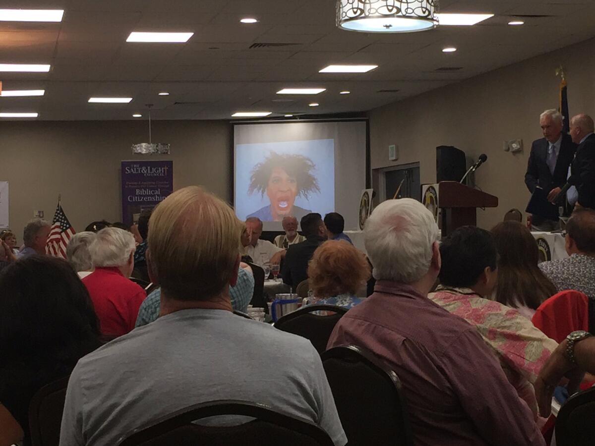 A doctored picture of Rep. Maxine Waters (D-Los Angeles) is put up on the screen at the Tea Party California Caucus meeting in Fresno. Tea partier Woody Woodrum said it was meant to be a joke.