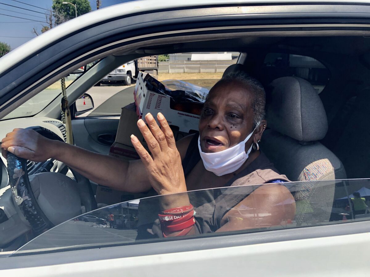 Jeanette Allen got four boxes of groceries at the food distribution drive-through at L.A. Regional Food Bank giveaway.