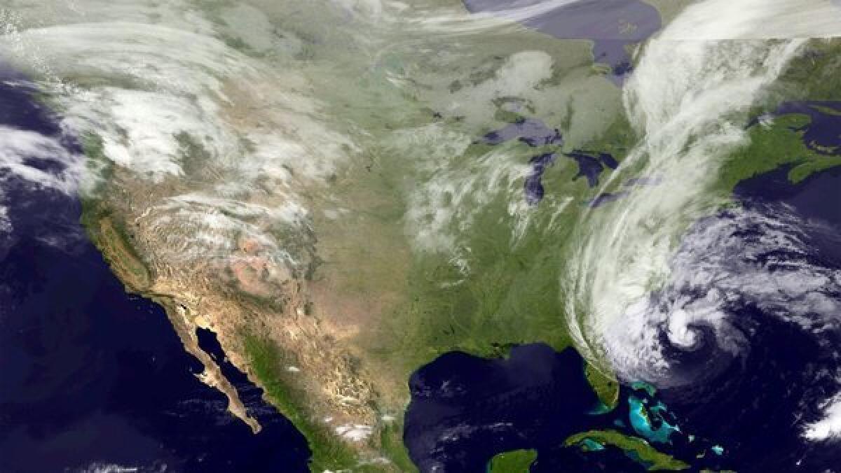 Hurricane Sandy, seen east of Georgia. The storm is forecast to track north and has caused the Obama campaign to cancel events in Virginia and Colorado.