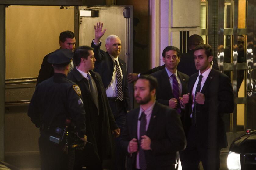 Vice President-elect Mike Pence, waving, leaves the Richard Rodgers Theatre in New York after a performance of "Hamilton."