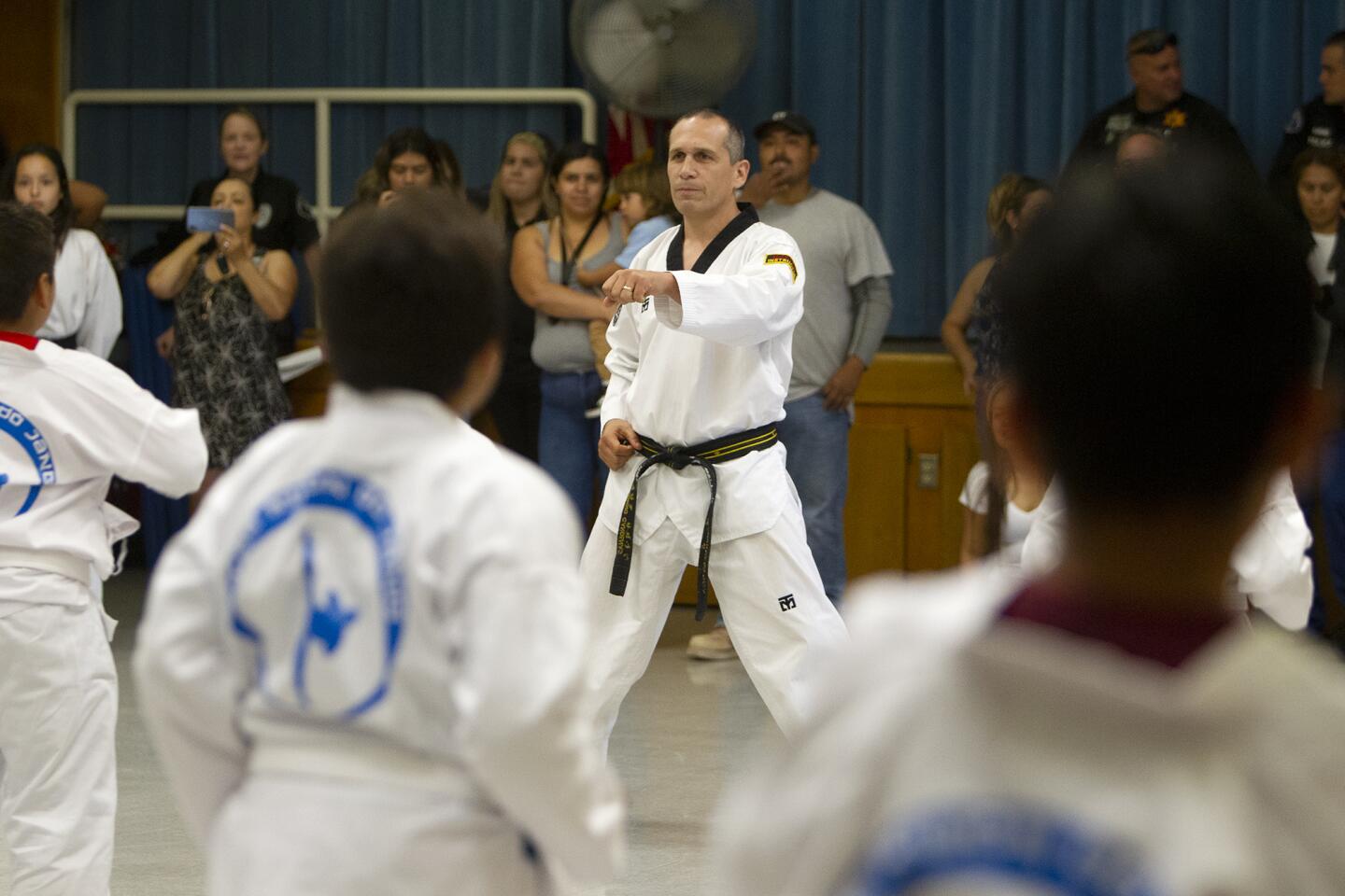 Master Sergio Cardenas, with Taekwondodojang in San Juan Capistrano, leads a group of teenagers in an exercise during a taekwondo summer camp at Wilson Elementary School in Costa Mesa on Tuesday, July 23. The event was hosted by the Orange County Gang Reduction Partnership (OC GRIP).