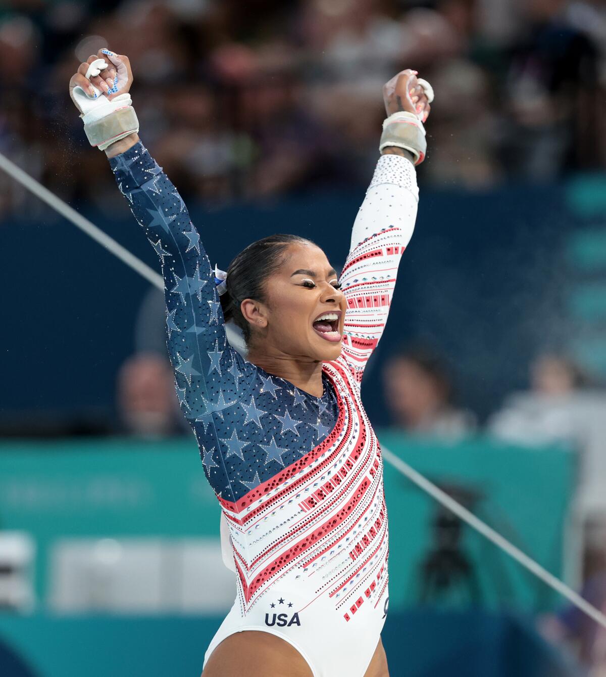 U.S. gymnast Jordan Chiles celebrates after completing her uneven bars routine