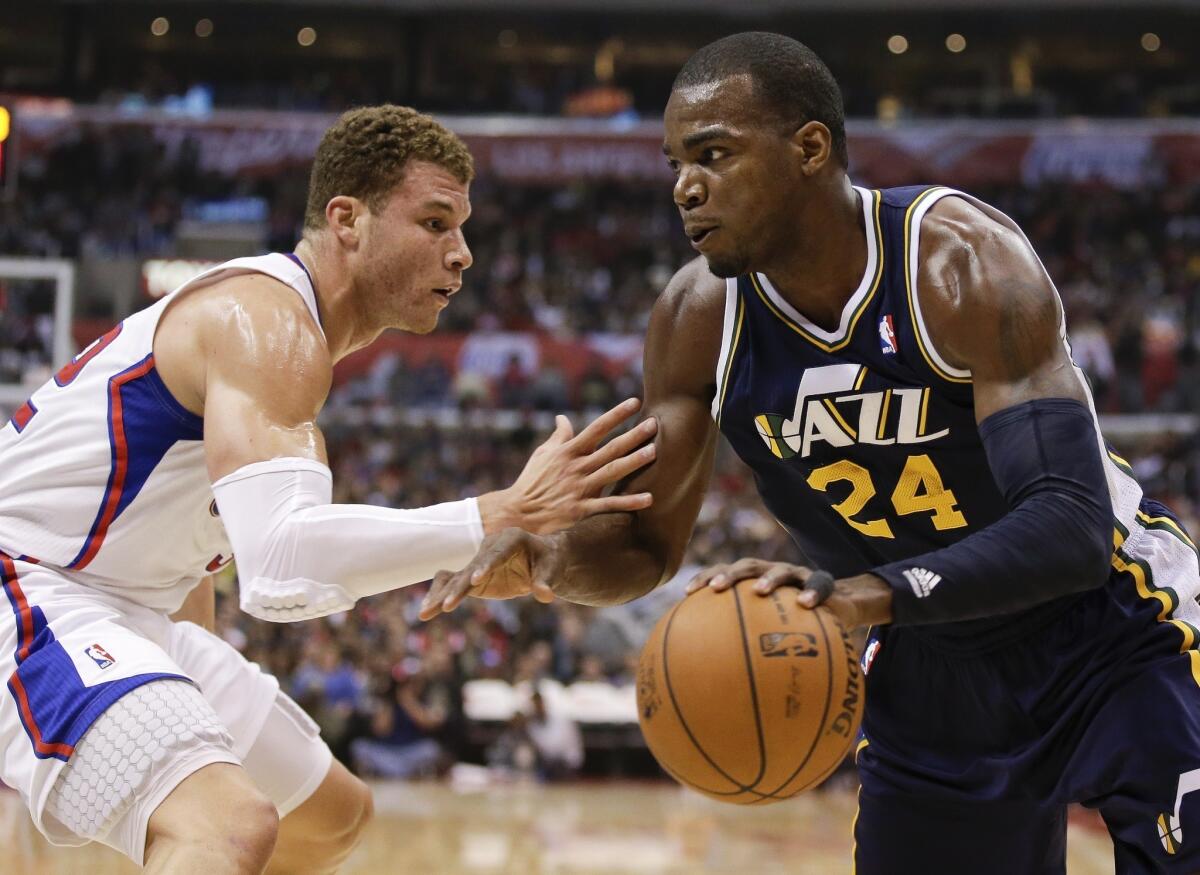 Clippers forward Blake Griffin defends Utah Jazz forward Paul Millsap. Milsap and the Jazz have the edge on the Lakers in the playoff race.