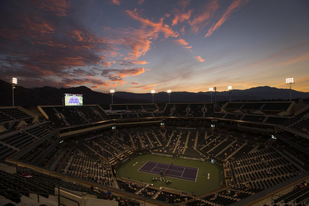 The sun sets behind the mountains during a match at BNP Paribas Open at Indian Wells Tennis Garden.