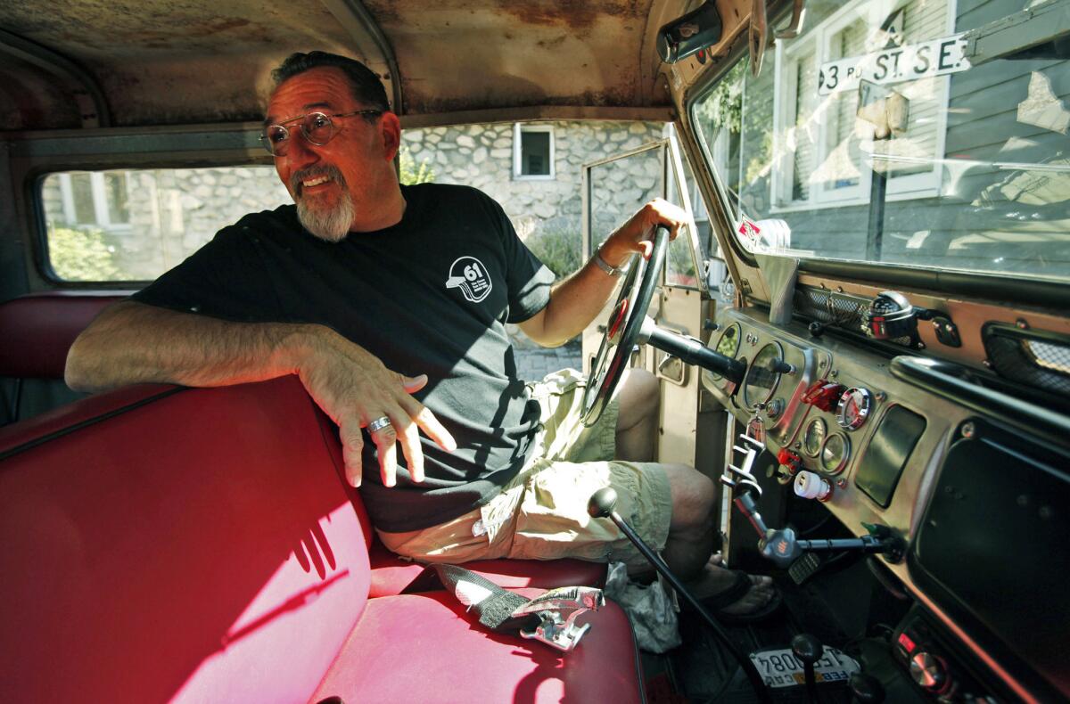 Dr. George Shapiro, a car collector, in his rare 1969 Nissan Patrol 60 at his Montrose garage full of parts and auto memorabilia.