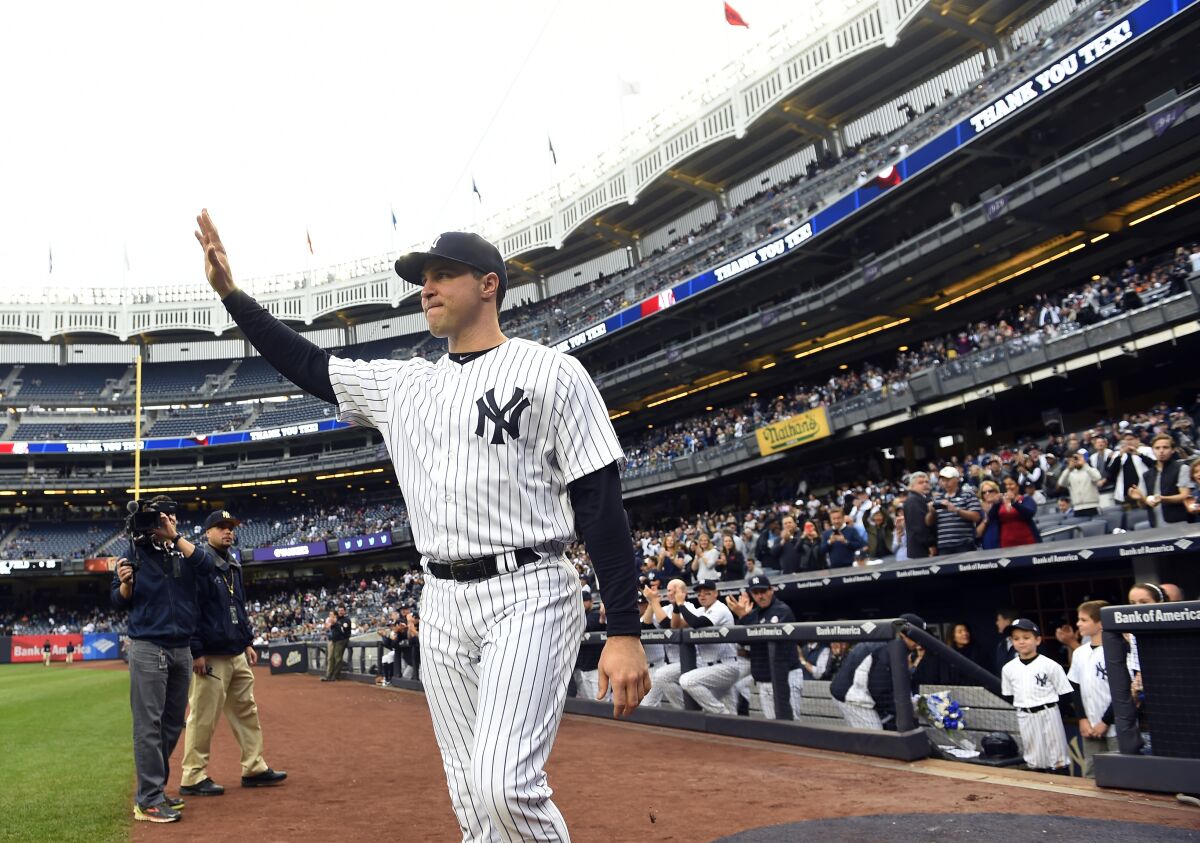 FILE - New York Yankees Mark Teixeira waves to the fans as he walks toward home plate for a ceremony to honor him on his retirement before the baseball game against the Baltimore Orioles, on Oct. 2, 2016, in New York. The Former major league star will graduate from Georgia Tech on Saturday, May 7, 2022, with a degree in business administration. Teixeira returned to the school in 2021, two decades after he left to begin his professional baseball career, and completed the final three semesters for his degree. (AP Photo/Kathy Kmonicek, File)
